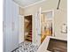 Spacious laundry room featuring modern patterned tile, storage cabinets, and utility sink at 8518 Shoreview Ct, Jonesboro, GA 30236