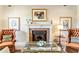 Cozy living room featuring a brick fireplace, comfortable seating, and decorative artwork at 8518 Shoreview Ct, Jonesboro, GA 30236