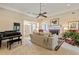Sophisticated living room showcasing a grand piano, fireplace, and comfortable furnishings at 8518 Shoreview Ct, Jonesboro, GA 30236