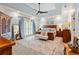 Relaxing main bedroom with tray ceiling, neutral walls, and a seating area with a king-size bed at 8518 Shoreview Ct, Jonesboro, GA 30236
