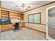Study featuring built-in bookshelves, a large window, and neutral-colored walls at 8518 Shoreview Ct, Jonesboro, GA 30236