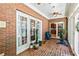 Sunroom with brick walls and floors, multiple windows, and access to the backyard at 8518 Shoreview Ct, Jonesboro, GA 30236