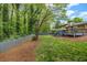 Expansive backyard featuring a well-maintained lawn, mature trees, and a spacious wooden deck, perfect for outdoor gatherings at 2921 Country Squire Ln, Decatur, GA 30033