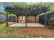 Charming backyard patio with a pergola, brick siding, and French doors for easy access at 2921 Country Squire Ln, Decatur, GA 30033