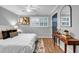 Bright bedroom featuring a white bedspread, hardwood floors, contemporary decor, and ample natural light at 2921 Country Squire Ln, Decatur, GA 30033