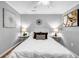 Cozy bedroom with a white bedspread, decorative pillows, hardwood floors, and stylish bedside tables with lamps at 2921 Country Squire Ln, Decatur, GA 30033
