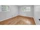 Bedroom features hardwood floors, neutral paint, and bright windows with leafy views at 2921 Country Squire Ln, Decatur, GA 30033