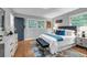 Bright bedroom with gray walls, wood floors, stylish decor, and an upholstered bench at the foot of the bed at 2921 Country Squire Ln, Decatur, GA 30033