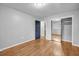 Bedroom with hardwood floors, neutral paint, closet, and bright window, with a view of trees at 2921 Country Squire Ln, Decatur, GA 30033