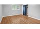 Bedroom with hardwood floors, neutral paint, closet, and window with blinds, bathed in natural light at 2921 Country Squire Ln, Decatur, GA 30033