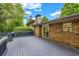 Spacious deck with a brick wall and a sliding door for easy indoor-outdoor living, complemented by a chimney at 2921 Country Squire Ln, Decatur, GA 30033