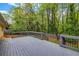 Large wooden deck surrounded by lush greenery, creating a private and serene outdoor space at 2921 Country Squire Ln, Decatur, GA 30033
