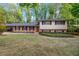 Traditional two-story home with a brick facade, neutral siding, well-maintained lawn, and a covered carport at 2921 Country Squire Ln, Decatur, GA 30033