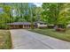 Charming split-level home with a long driveway, a two-car carport, and manicured landscaping at 2921 Country Squire Ln, Decatur, GA 30033