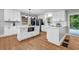 Bright kitchen boasts white cabinets, quartz counters, stainless appliances, and hardwood floors at 2921 Country Squire Ln, Decatur, GA 30033