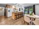 Open kitchen with an island, bar stool seating, stainless steel appliances, and hardwood floors at 2921 Country Squire Ln, Decatur, GA 30033