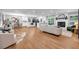 Open-concept living space features hardwood floors, fireplace, modern furniture, and a view of the kitchen at 2921 Country Squire Ln, Decatur, GA 30033