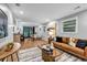 Open living space featuring wood floors, neutral walls, and a kitchen in the background at 2921 Country Squire Ln, Decatur, GA 30033