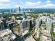 Breathtaking aerial view of a vibrant city skyline surrounding modern residential buildings and lush green spaces at 3107 Peachtree Ne Rd # 1403, Atlanta, GA 30305