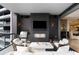 Inviting covered balcony features an outdoor kitchen with a TV, grill, and fireplace at 3107 Peachtree Ne Rd # 1403, Atlanta, GA 30305