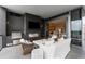 Inviting covered balcony features an outdoor kitchen with a TV, grill, and fireplace at 3107 Peachtree Ne Rd # 1403, Atlanta, GA 30305