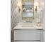 Stylish bathroom featuring designer wallpaper, modern vanity, and sconces with an ornate mirror at 3107 Peachtree Ne Rd # 1403, Atlanta, GA 30305