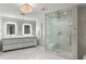 Modern bathroom featuring a double vanity, glass enclosed shower, and marble tile at 3107 Peachtree Ne Rd # 1403, Atlanta, GA 30305