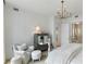 Well-lit bedroom with a plush chair, an ornate table, and modern decor throughout the space at 3107 Peachtree Ne Rd # 1403, Atlanta, GA 30305