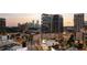 Contemporary high-rise exterior with city skyline view during the early evening, offering urban sophistication at 3107 Peachtree Ne Rd # 1403, Atlanta, GA 30305