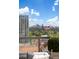 Balcony view of the city skyline, trees, and American flag at 3107 Peachtree Ne Rd # 1403, Atlanta, GA 30305