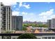 Balcony view of the city skyline, trees, and American flag at 3107 Peachtree Ne Rd # 1403, Atlanta, GA 30305