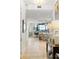 Hallway looking into dining room and kitchen with hardwood floors, modern lighting, and tasteful decor at 3107 Peachtree Ne Rd # 1403, Atlanta, GA 30305