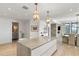 Modern kitchen featuring an island with seating, a bar area, and a view into the dining room at 3107 Peachtree Ne Rd # 1403, Atlanta, GA 30305