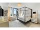 Bright main bedroom featuring a four poster bed, sitting area, and stunning city views at 3107 Peachtree Ne Rd # 1403, Atlanta, GA 30305