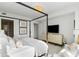 Bright main bedroom with a four-poster bed and adjoining sitting area at 3107 Peachtree Ne Rd # 1403, Atlanta, GA 30305