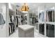 Large walk-in closet featuring custom shelving and glass door cabinets at 3107 Peachtree Ne Rd # 1403, Atlanta, GA 30305
