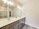 Bathroom features double sink vanity with a large mirror and modern fixtures at 89 Little Magnolia Ln, Auburn, GA 30011