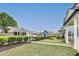 Community green space with well-manicured grass, mature trees, and charming neighborhood buildings at 89 Little Magnolia Ln, Auburn, GA 30011
