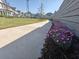 Scenic community path featuring colorful flowers, well-kept lawns, and sidewalks, enhancing neighborhood aesthetics and walkability at 89 Little Magnolia Ln, Auburn, GA 30011