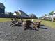 Community fire pit area with Adirondack chairs and well-maintained landscaping at 89 Little Magnolia Ln, Auburn, GA 30011