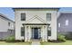 Charming two-story home featuring a blue front door, a cozy porch, and manicured landscaping at 89 Little Magnolia Ln, Auburn, GA 30011