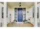 Inviting front porch with blue door, decorative plants, and a welcome sign, creating a warm entrance at 89 Little Magnolia Ln, Auburn, GA 30011