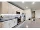 Bright kitchen with white cabinets, stainless appliances, tile backsplash, and eat-in island at 89 Little Magnolia Ln, Auburn, GA 30011