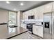 Modern kitchen featuring white cabinets, stainless steel appliances, and a gray countertop island at 89 Little Magnolia Ln, Auburn, GA 30011