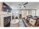 Comfortable living room with fireplace, hardwood floors, and a large leather sofa, perfect for relaxation at 89 Little Magnolia Ln, Auburn, GA 30011