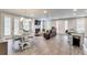 Open-concept living room with abundant natural light, hardwood floors, fireplace, and comfortable seating at 89 Little Magnolia Ln, Auburn, GA 30011