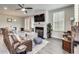 Inviting living room with a cozy fireplace, hardwood floors, comfortable seating, and abundant natural light at 89 Little Magnolia Ln, Auburn, GA 30011
