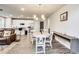 Open living space featuring hardwood floors, a modern kitchen, dining area, and comfortable seating at 89 Little Magnolia Ln, Auburn, GA 30011