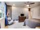 Comfortable main bedroom with unique decor, ceiling fan, sitting area and access to bathroom at 89 Little Magnolia Ln, Auburn, GA 30011