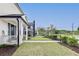 Well-maintained side yard with lush grass, manicured hedges, and a sidewalk leading to neighboring homes at 89 Little Magnolia Ln, Auburn, GA 30011